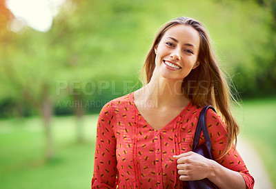 Buy stock photo Shot of a young woman taking a walk in the park