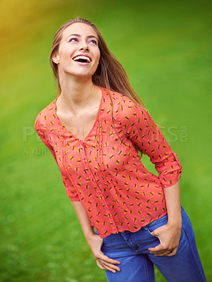 Buy stock photo Shot of a carefree young woman enjoying a day in the outdoors