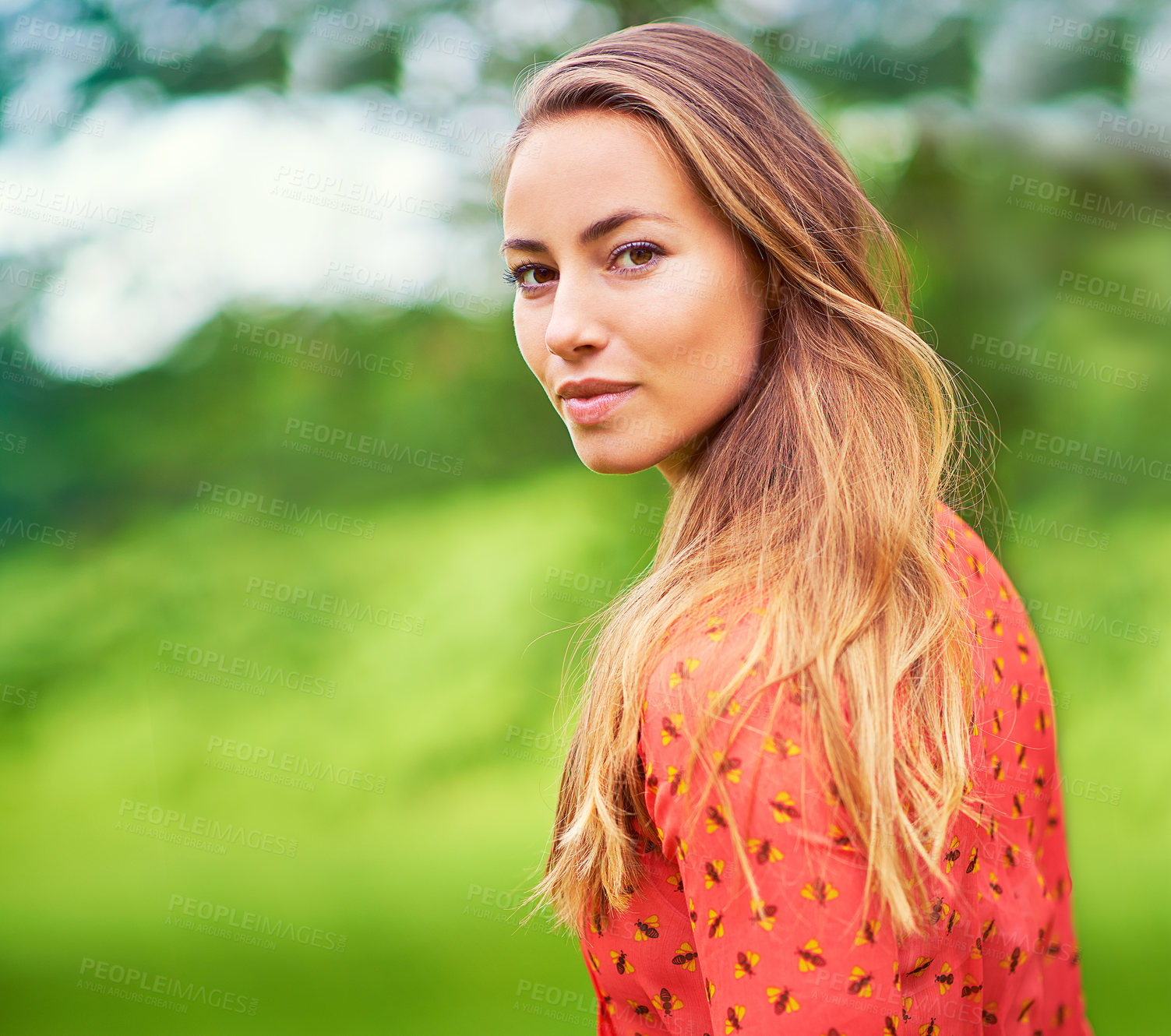 Buy stock photo Cropped portrait of a young woman standing in the outdoors