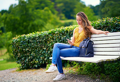 Buy stock photo Woman, park and bench with smartphone outside, relax and calm in nature with social media app for communication. Browsing, internet connection and reading blog in summer, weekend break and texting