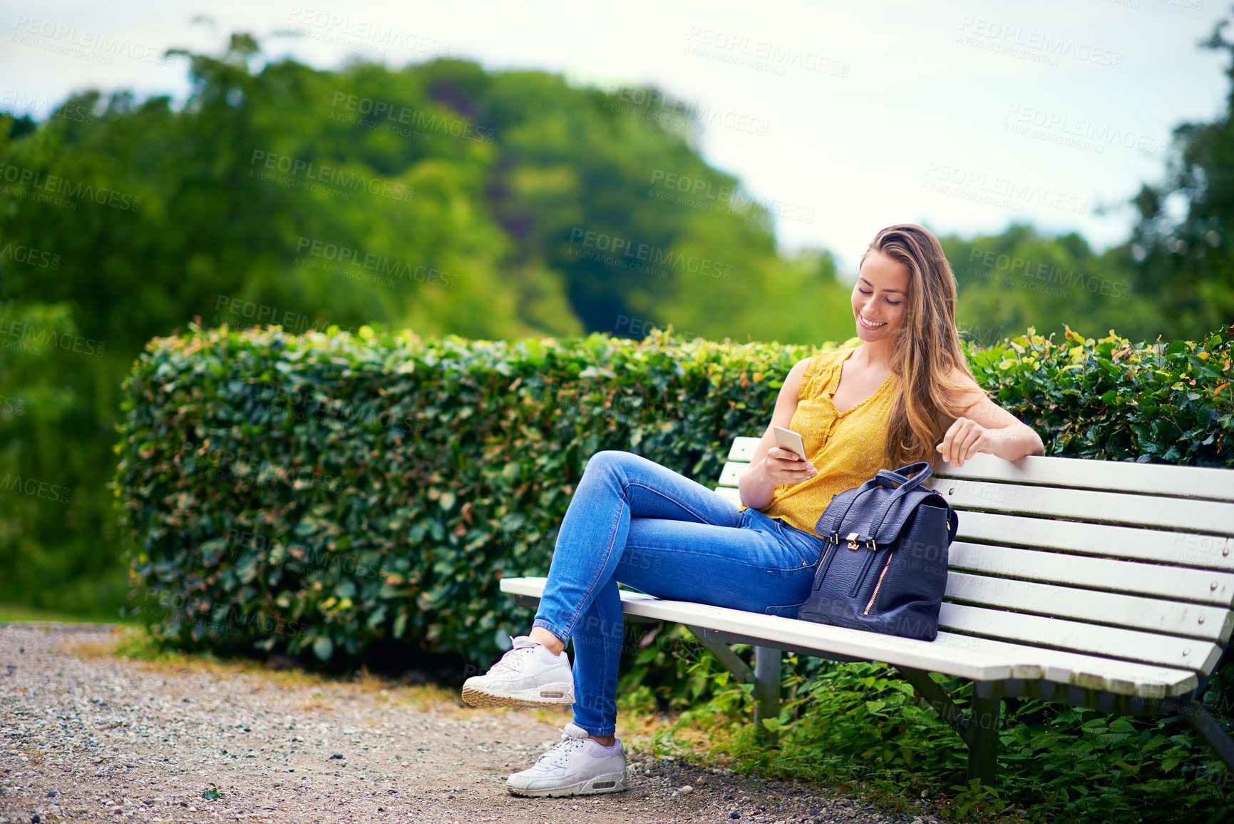 Buy stock photo Woman, park and smile with smartphone for online dating or social media  for networking and fun. Female person, outdoor and happy with waiting for date on mobile app for communication in New York