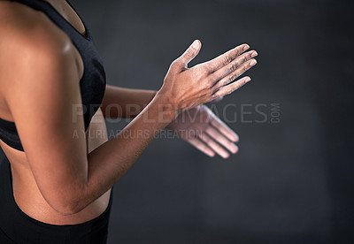 Buy stock photo Shot of a female athlete coating her hands with sports chalk