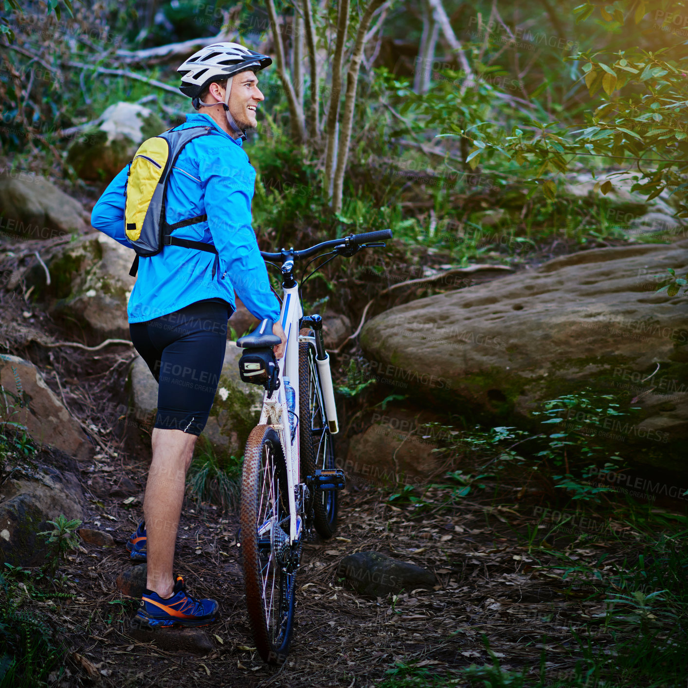 Buy stock photo Shot of a male cyclist out for a ride on his mountain bike