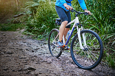 Buy stock photo Cropped shot of a male cyclist riding along a mountain bike trail