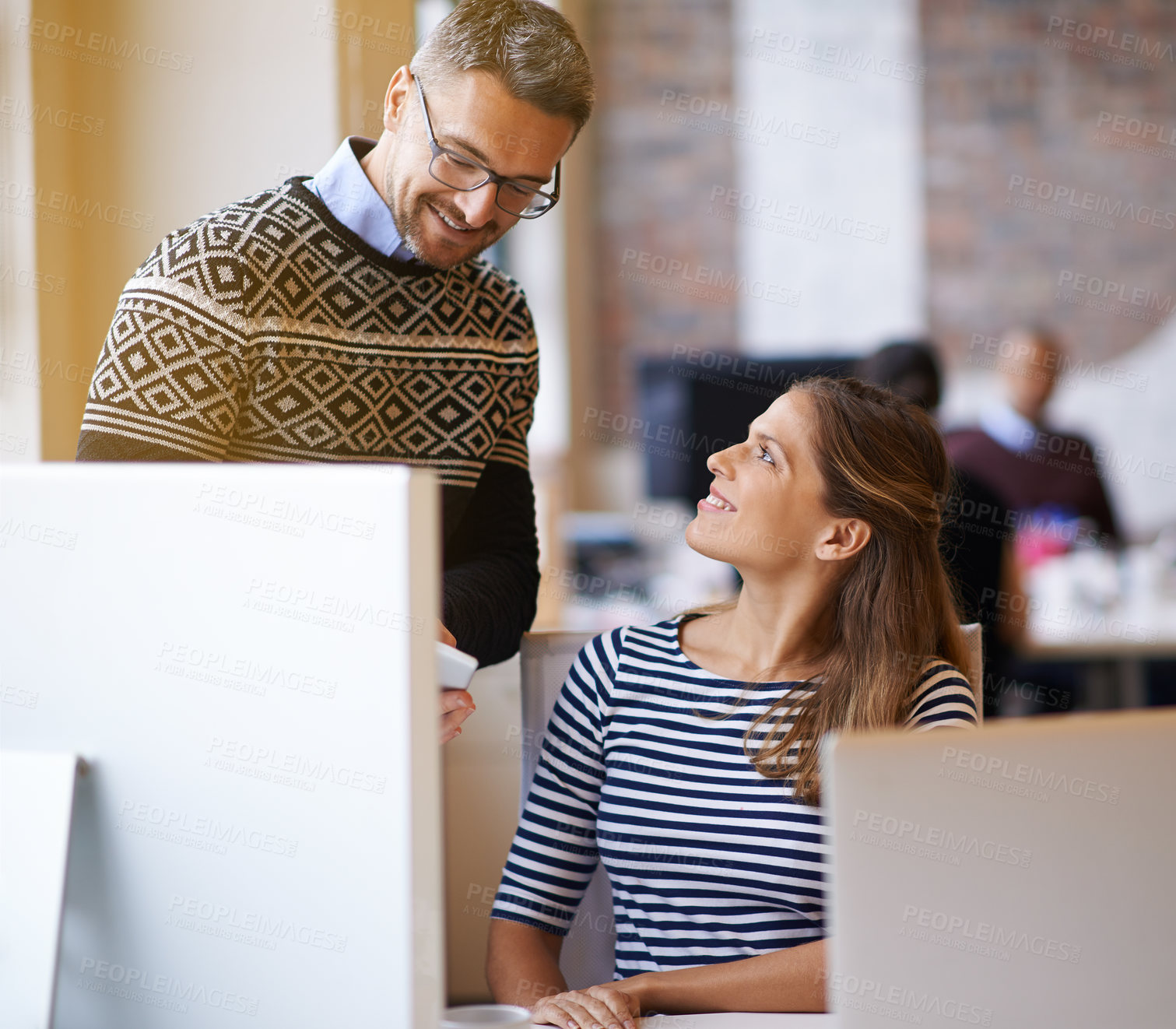 Buy stock photo Shot of two designers working together at a computer