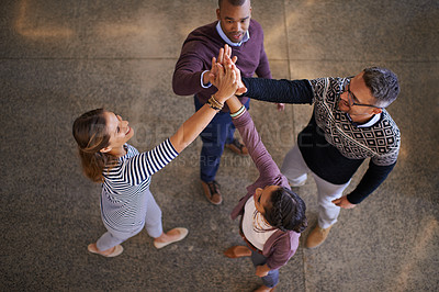 Buy stock photo High angle shot of a group of coworkers giving each other a high five