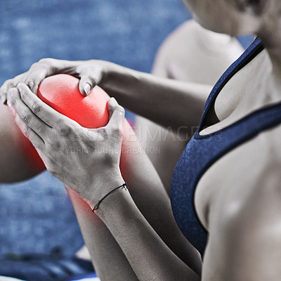 Buy stock photo Cropped shot of a young woman holding her injured knee that's highlighted in red