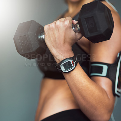 Buy stock photo Cropped shot of a fit woman working out with weights