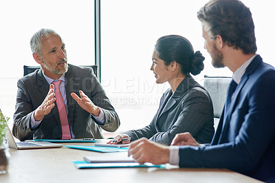Buy stock photo Shot of a group of executives having a meeting in a boardroom