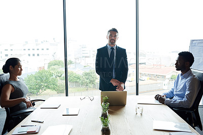 Buy stock photo Business leader, boss and ceo looking confident and serious while standing in a boardroom during a meeting or briefing. Portrait of a mature corporate executive showing great leadership in an office