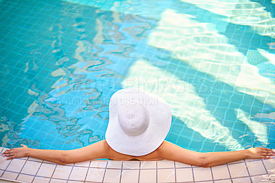 Buy stock photo Swimming pool, relax and back of woman on holiday, vacation and weekend at hotel resort. Luxury hospitality, travel and person with summer hat for wellness, peace and resting in water to chill