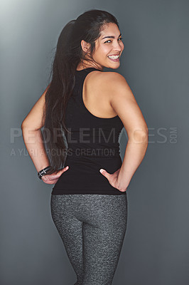 Buy stock photo Portrait of a fit young woman in sports clothing posing against a gray background