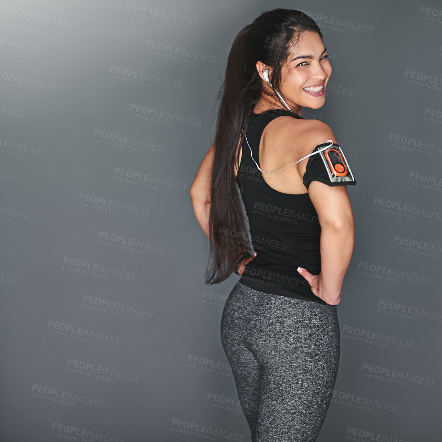 Buy stock photo Portrait of a fit young woman in sports clothing posing against a gray background