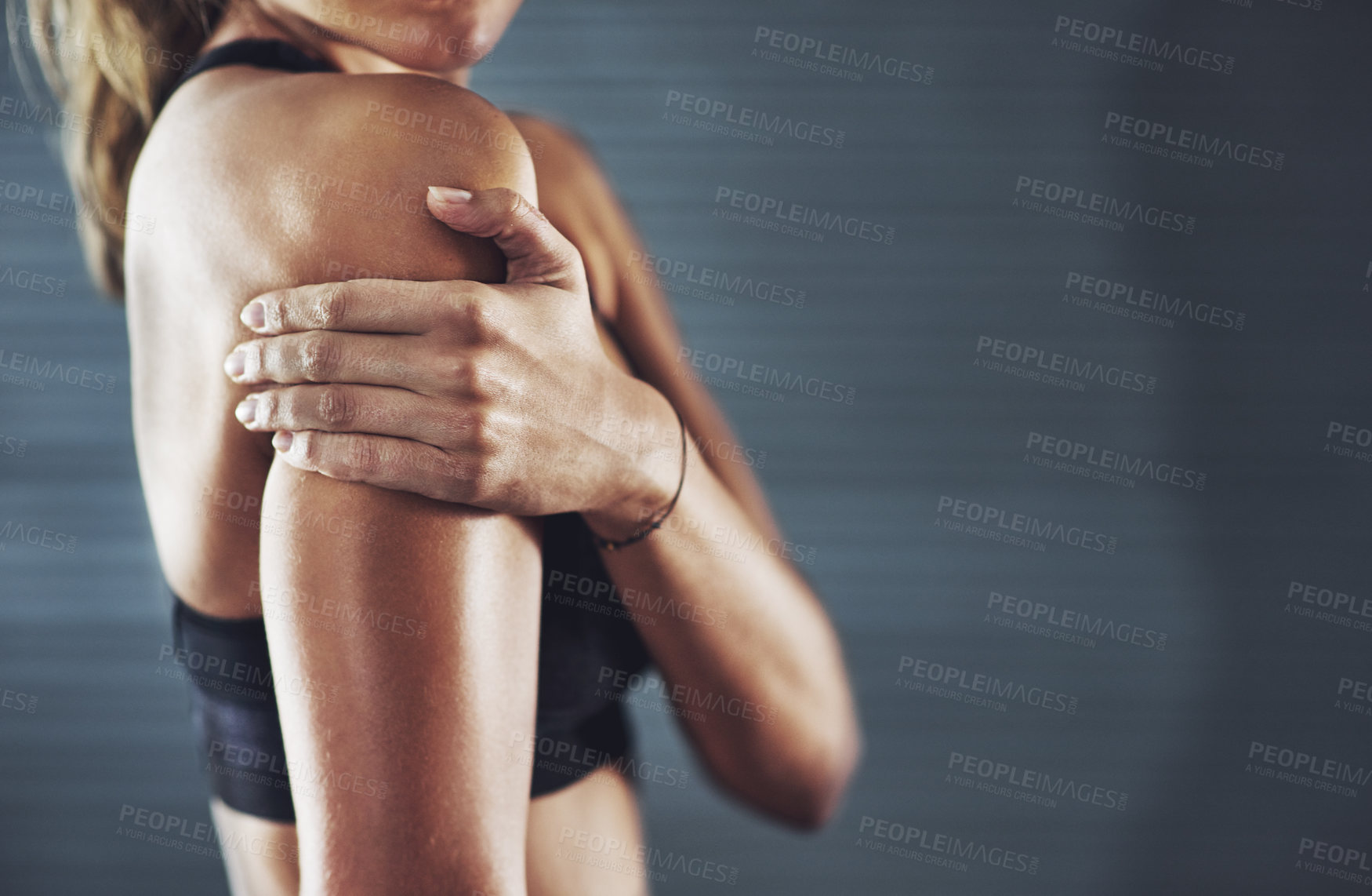 Buy stock photo Shot of a sportswoman with a shoulder injury