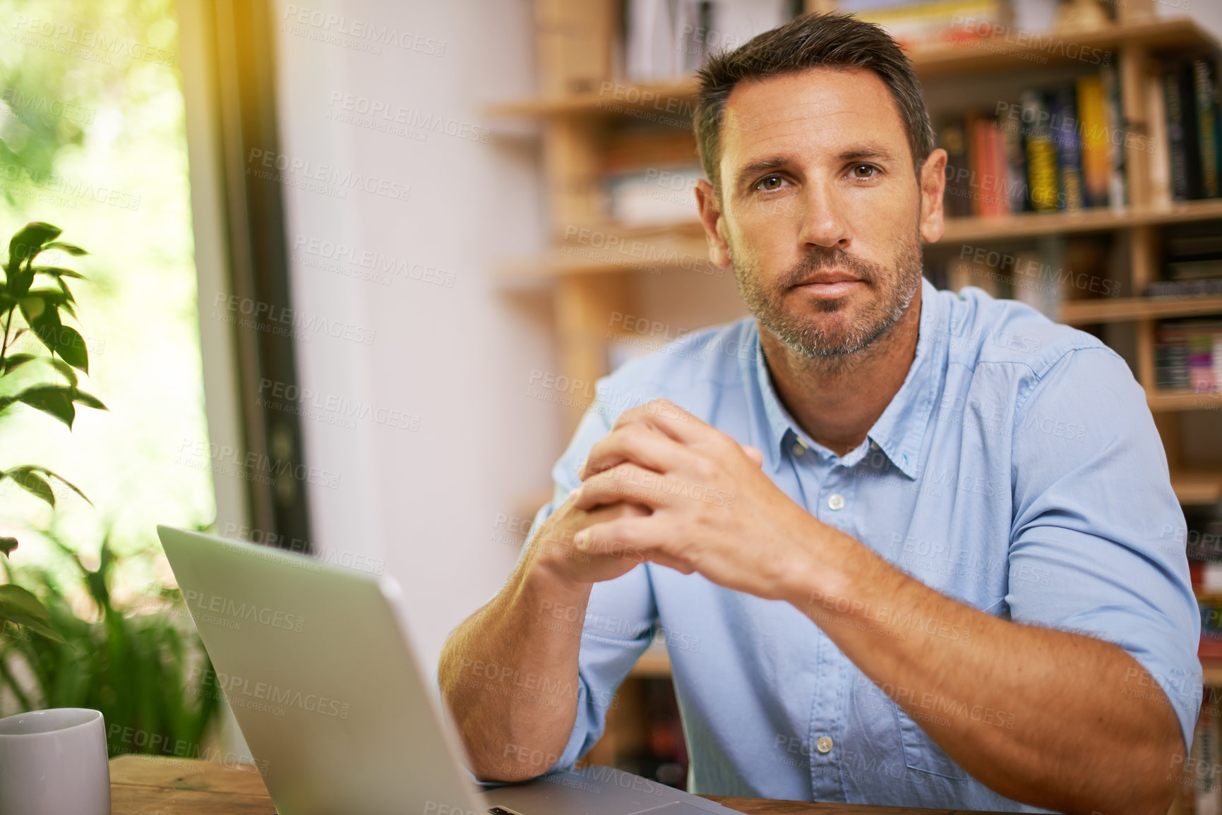 Buy stock photo Shot of a young man working from home