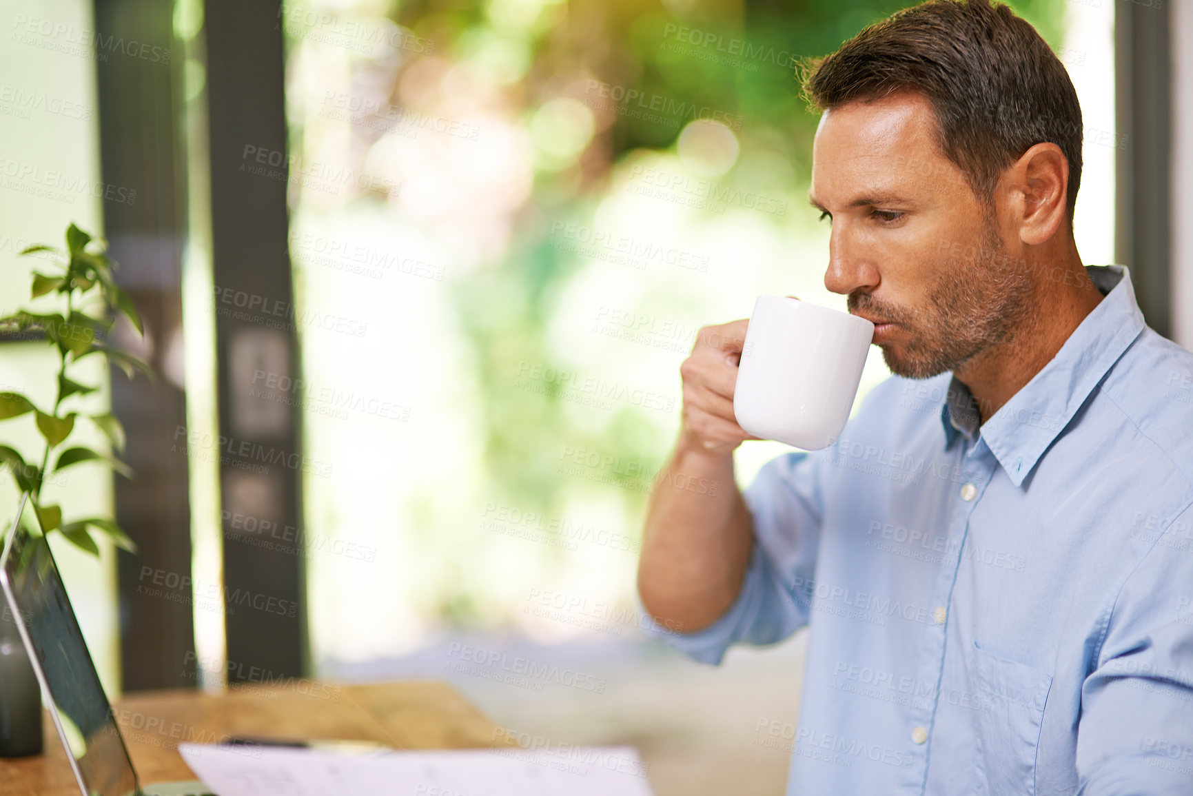 Buy stock photo Coffee, remote work and business man in home in morning with beverage, latte and caffeine for breakfast. Freelance, entrepreneur and person with drink on laptop for research, website and online