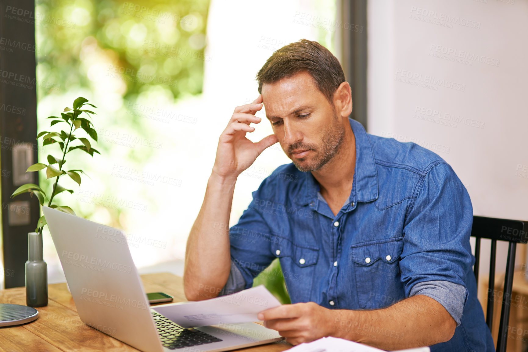 Buy stock photo Stress, documents and man in home on laptop for budget, financial review and mortgage payment. Thinking, computer and frustrated with paperwork for insurance, investment and finance bill headache