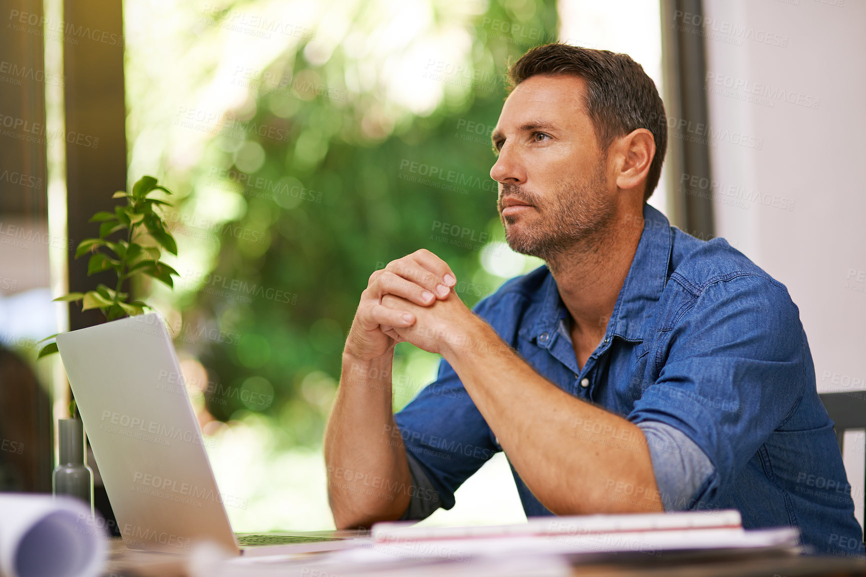 Buy stock photo Shot of a man looking thoughtful while working from home
