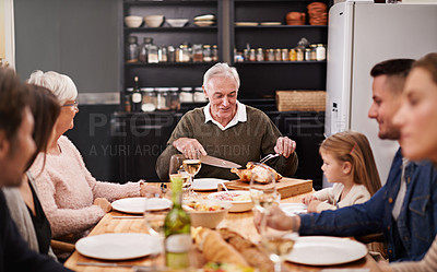 Buy stock photo Cropped shot of a family sitting down to dinner