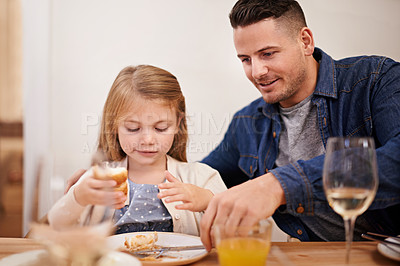 Buy stock photo Father, child and help with meal in home, food and healthy lunch for nutrition at dining table. Daddy, girl and teaching to eat or development in apartment, wellness and bonding or support in house