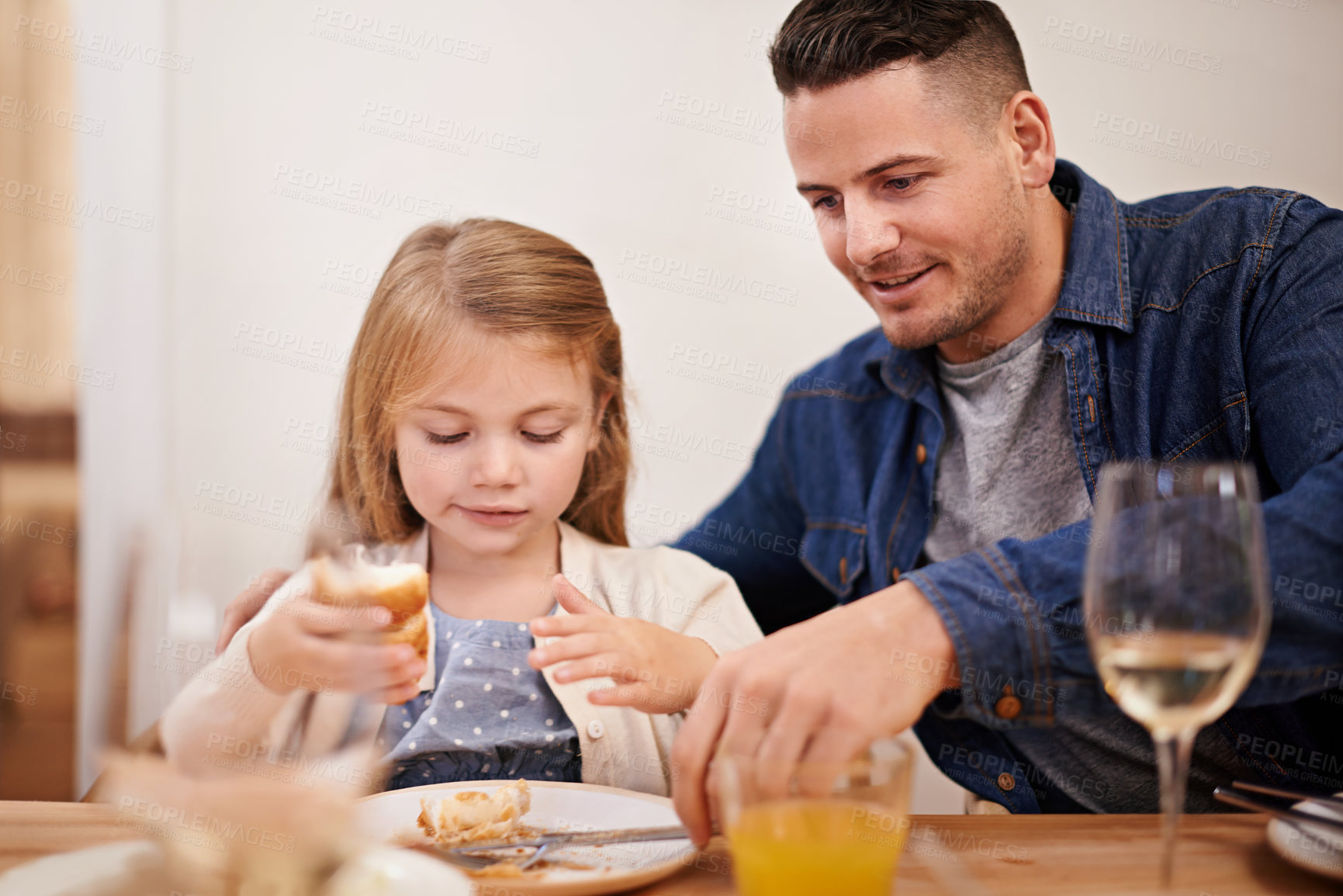 Buy stock photo Father, child and help with meal in home, food and healthy lunch for nutrition at dining table. Daddy, girl and teaching to eat or development in apartment, wellness and bonding or support in house