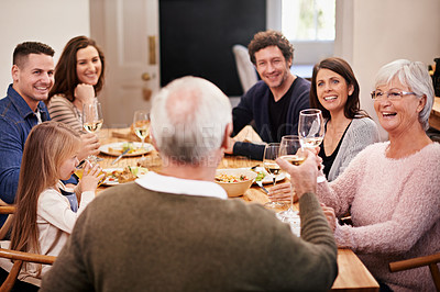 Buy stock photo Cropped shot of a family sitting down to dinner