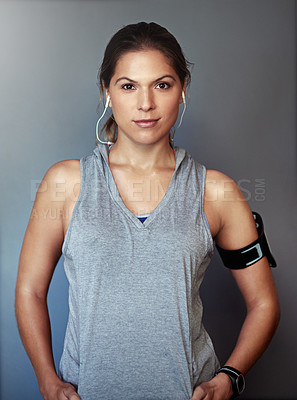 Buy stock photo Studio portrait of a sporty young woman standing against a gray background