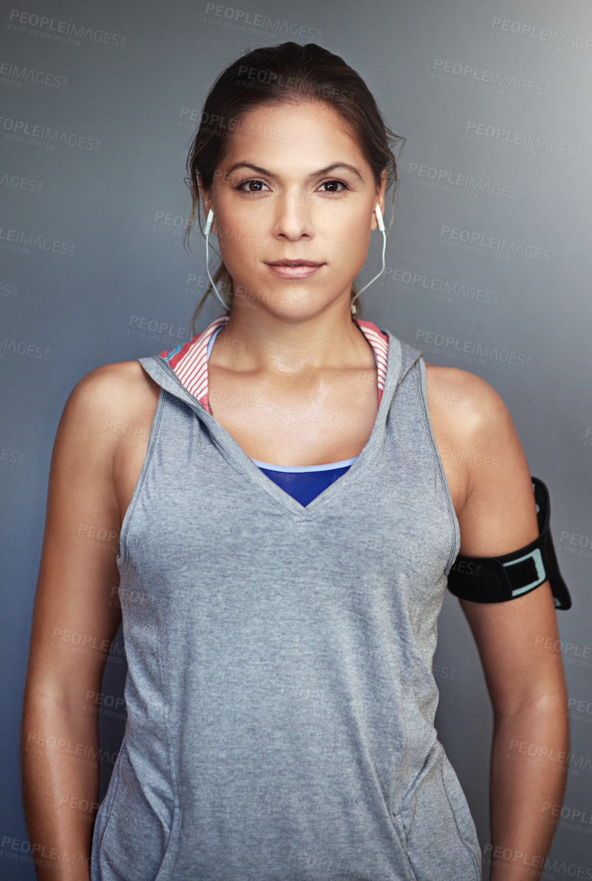 Buy stock photo Studio portrait of a sporty young woman standing against a gray background