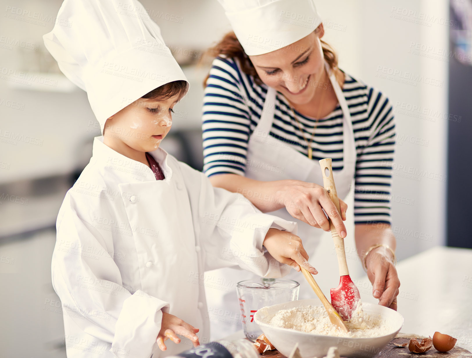 Buy stock photo Shot of a mother and her son baking in the kitchen