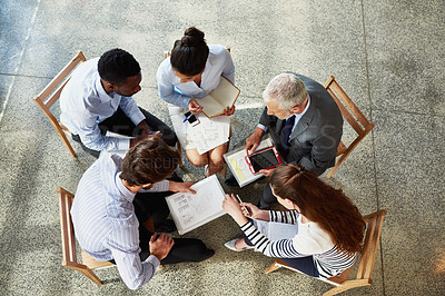 Buy stock photo High angle shot of a group of coworkers sitting around in a circle