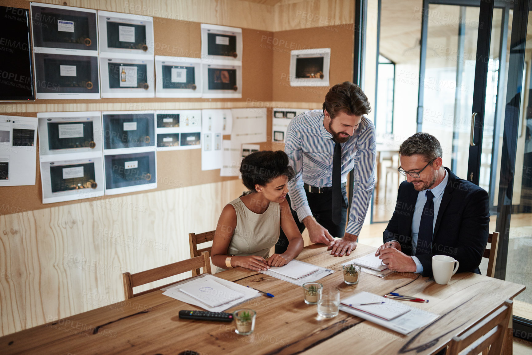 Buy stock photo Shot of a group of colleagues working together in an office