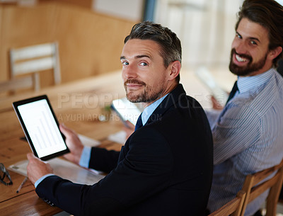 Buy stock photo Portrait of a businessman using a digital tablet during a conference