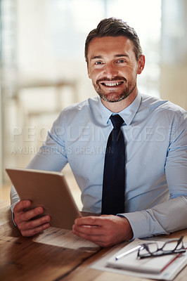Buy stock photo Shot of a businessman using a digital tablet