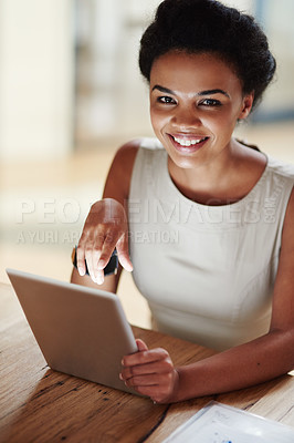 Buy stock photo Shot of a businesswoman using a digital tablet in an office