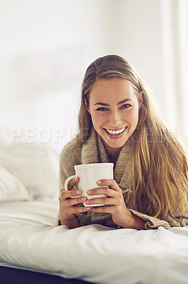 Buy stock photo Portrait of a young woman enjoying a warm beverage at home