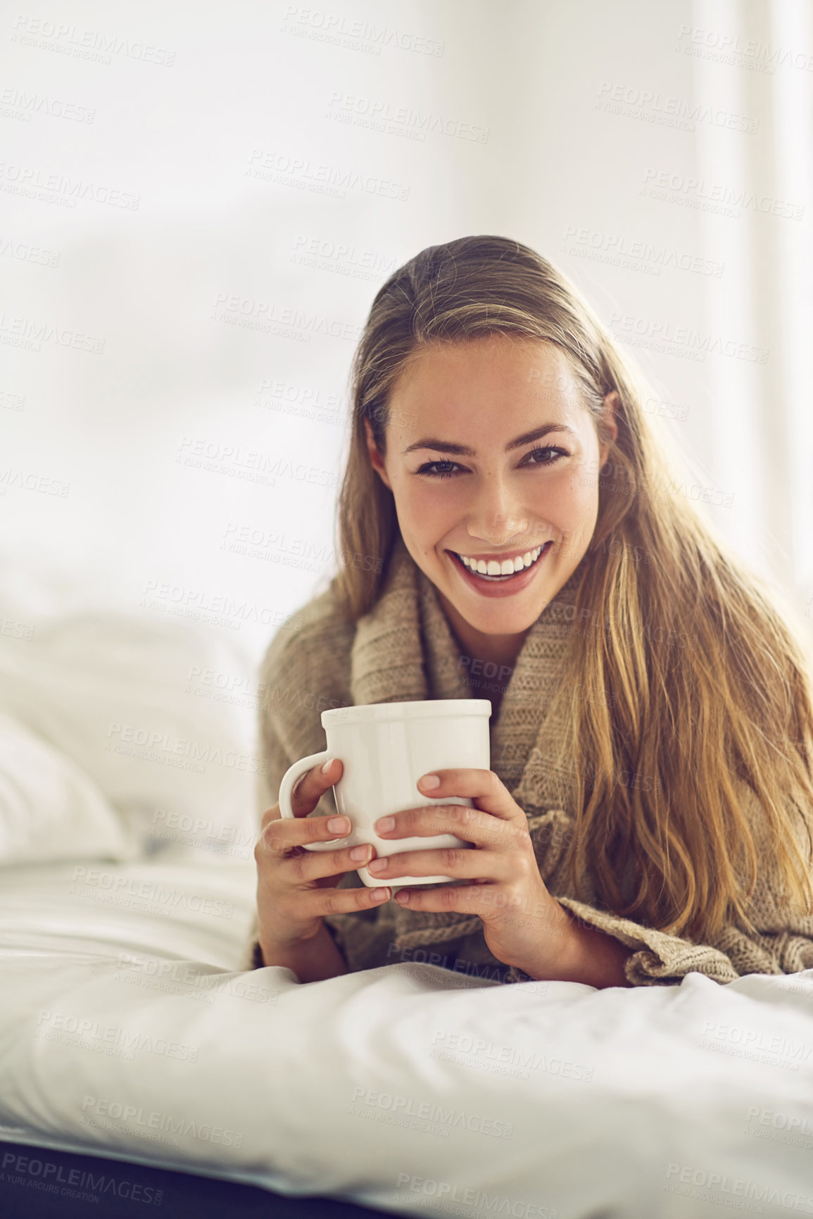 Buy stock photo Portrait of a young woman enjoying a warm beverage at home