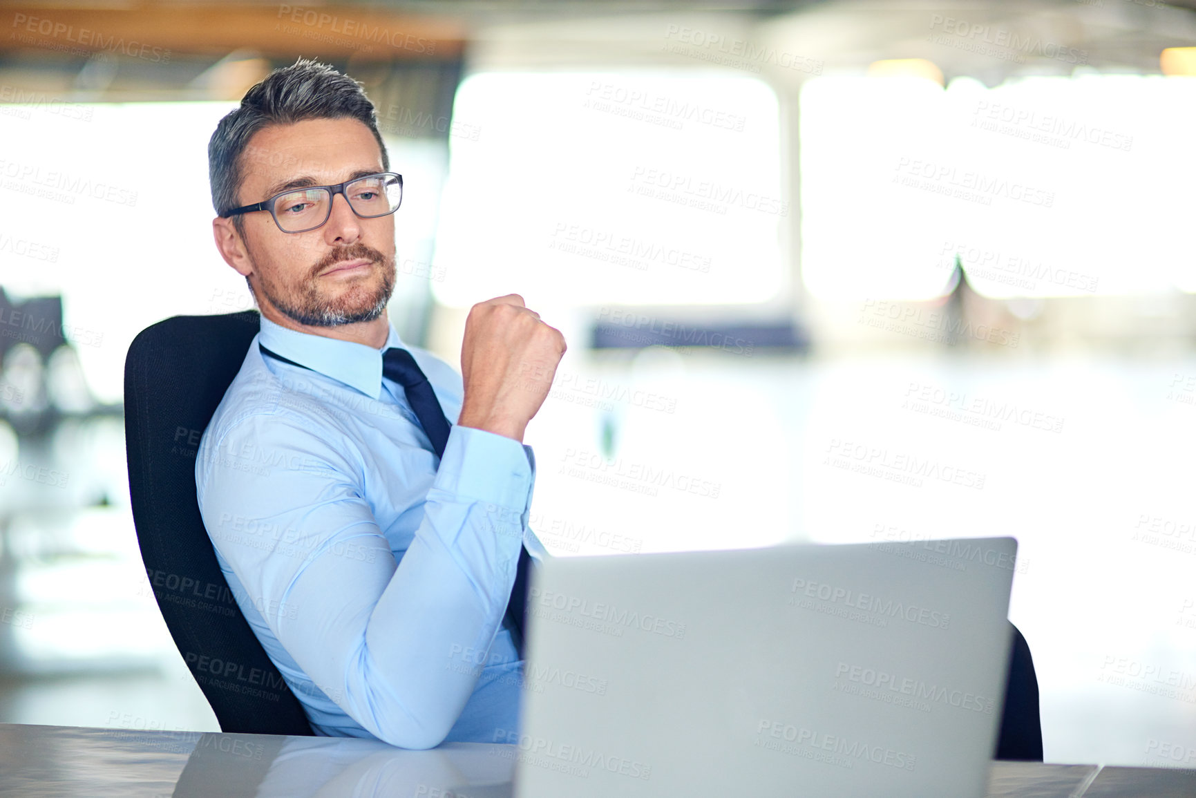 Buy stock photo Shot of a businessman using a laptop in the office