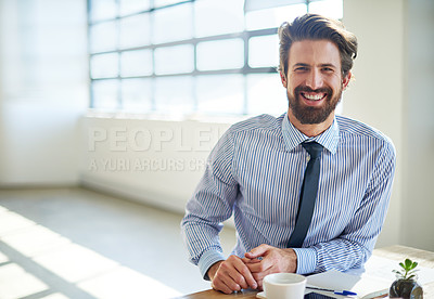 Buy stock photo Cropped portrait of a young businessman sitting in his office