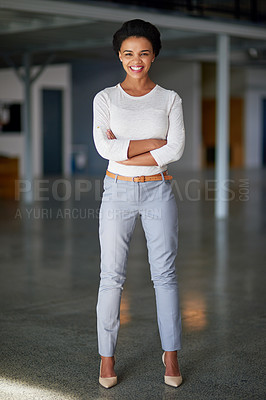 Buy stock photo Full length portrait of a young businesswoman standing with her arms folded in the office