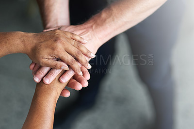 Buy stock photo Cropped shot of two people's hands together in unity