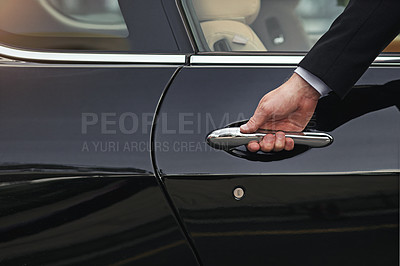 Buy stock photo Cropped shot of a well dressed man opening a car door