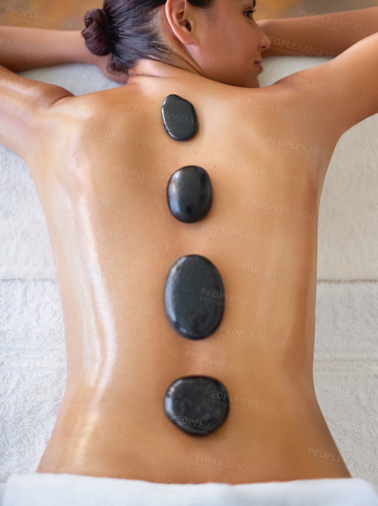 Buy stock photo Top view, woman and hot stone massage at spa for relax, wellness and stress relief at luxury resort. Back, rocks and person in beauty therapy at salon for body treatment, detox and healing for health