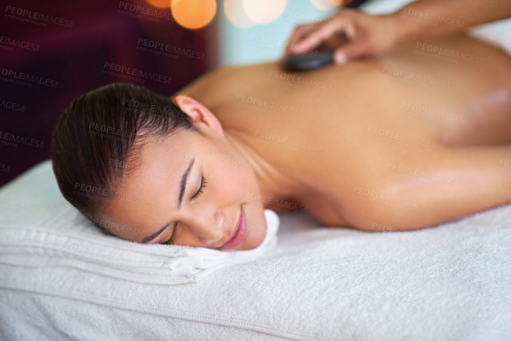 Buy stock photo Calm, woman or hot stone massage with therapist at salon for peace, wellness or relax for health. Hand, masseur or rocks on back at spa for body care treatment, detox or healing spine for pain relief