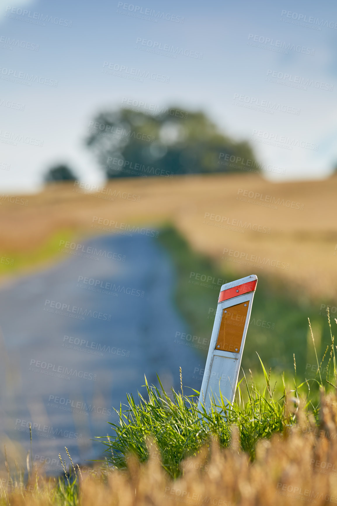 Buy stock photo Reflector, post and road for travel outdoor in nature for vehicle guide, direction and safety in countryside. Street, environment and marker with transport navigation, visual hazards and traffic path