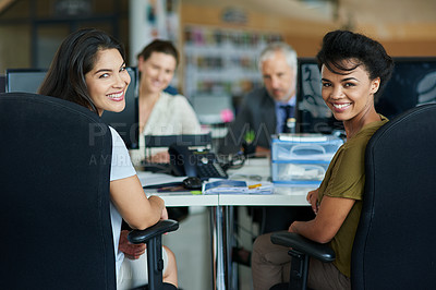 Buy stock photo Portrait of colleagues working on their computers while sitting in an office