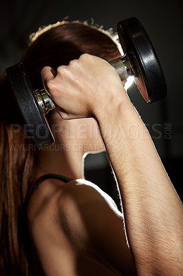 Buy stock photo Cropped shot of a woman working out with weights