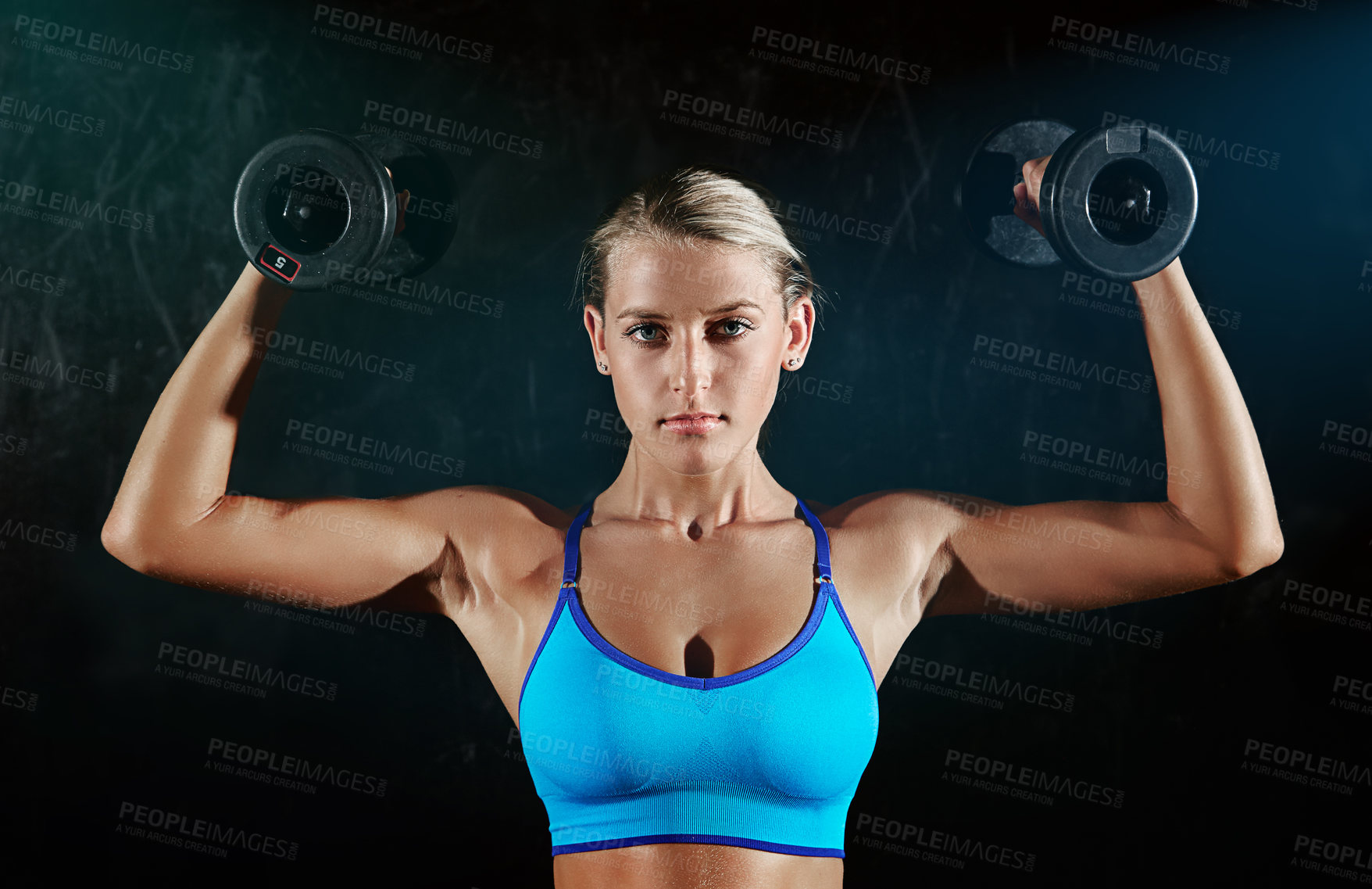 Buy stock photo Portrait of a young woman working out with weights