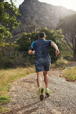 Buy stock photo Rearview shot of a young man running outdoors