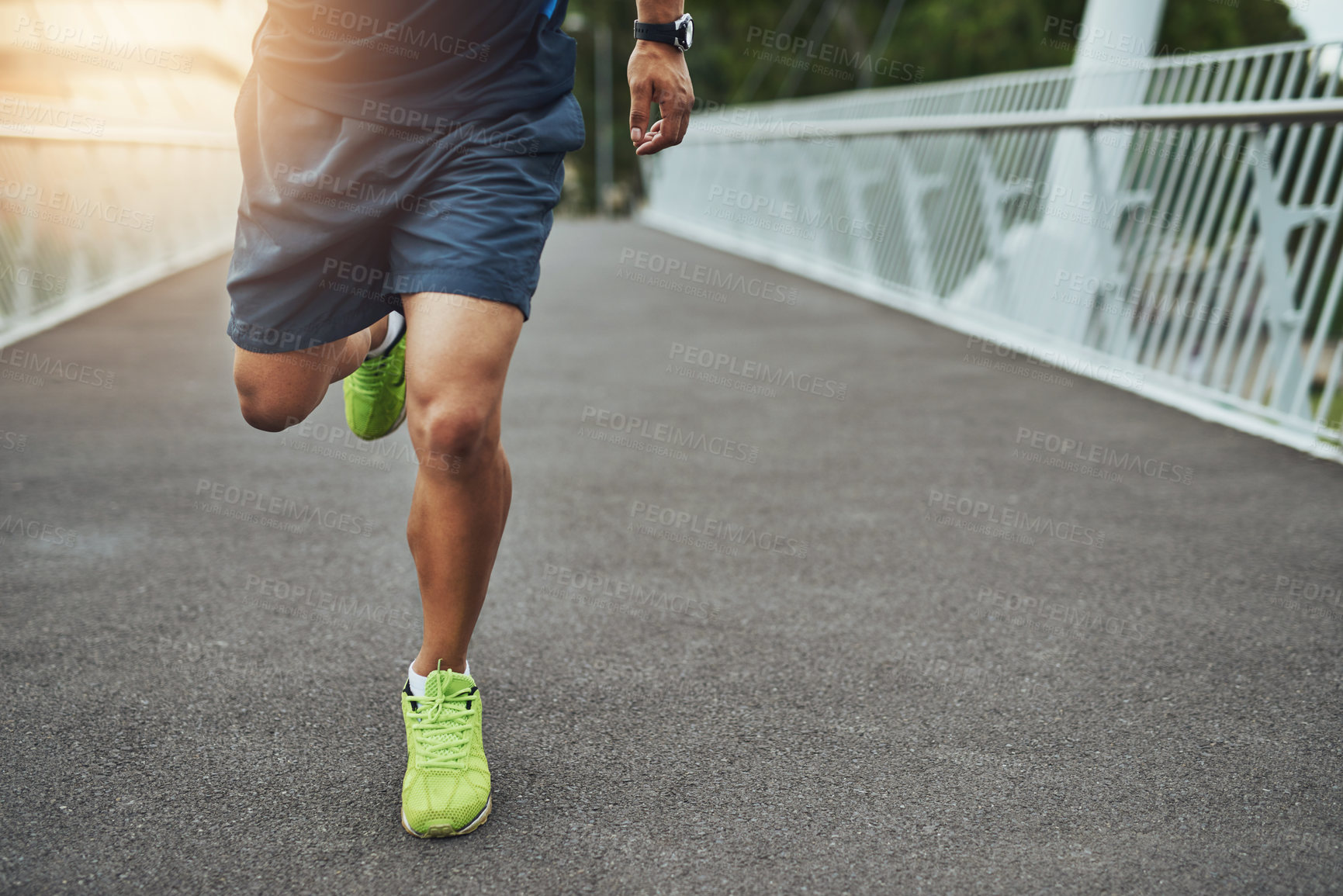 Buy stock photo Shot of a man's legs as he's running across a bridge