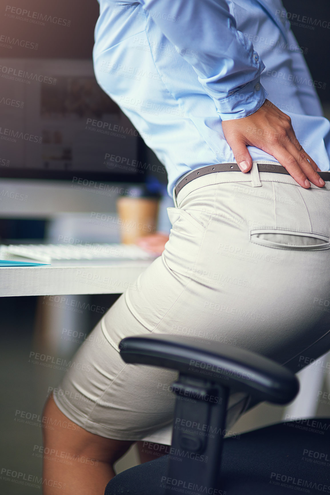 Buy stock photo Desk, back pain and business woman in office with injury, muscle inflammation or overworked. Rear view, health emergency and female employee with spine problem for sprain, discomfort or burnout